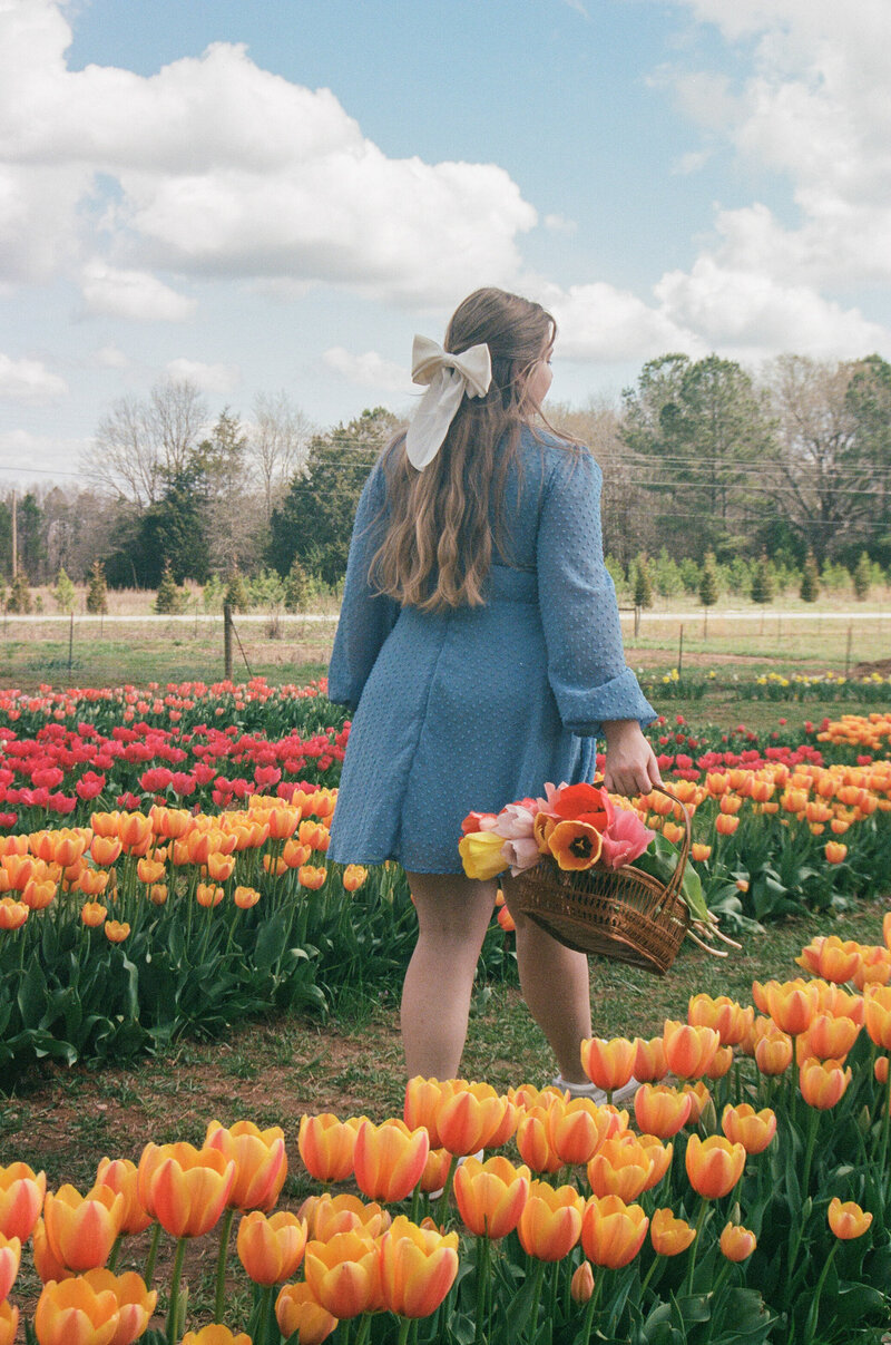 Film photo of girl in flower field