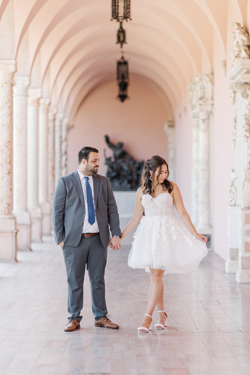 engaged couple hugging on a bridge