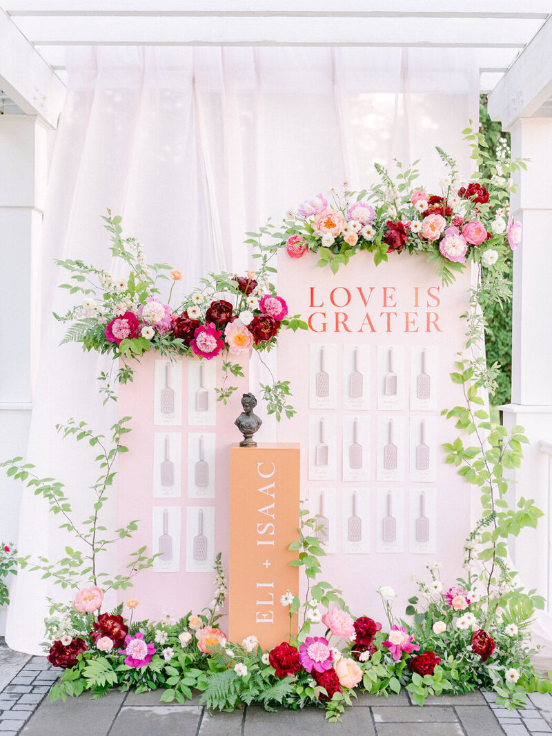 A lush, elaborate place card flower display at a wedding reception at Stonehaven Manor.