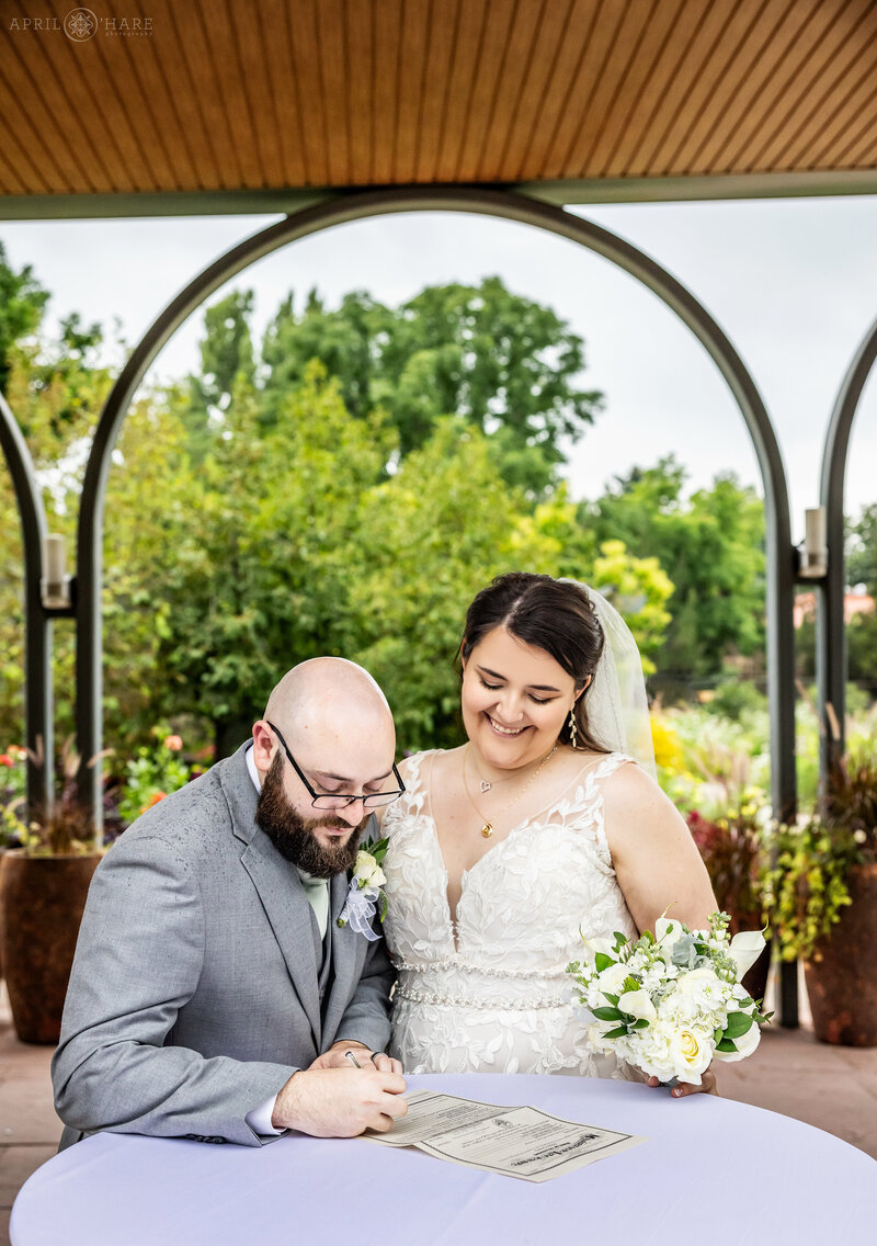 Couple Sign their marriage license in the Annuals Garden at Denver Botanic Gardens