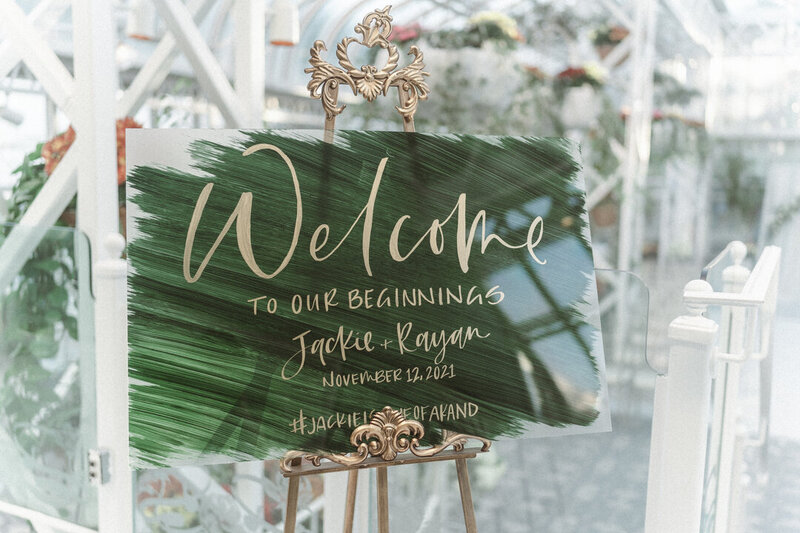 Emerald green acrylic welcome sign with gold hand written calligraphy