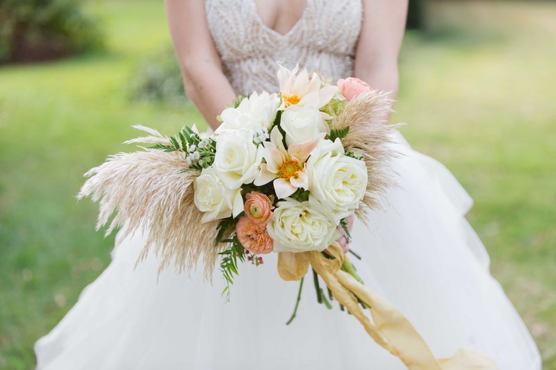Bride holds a great gatsby inspired fern bouquet