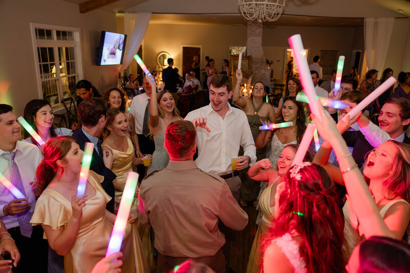 A hype dance party with foam light sticks, electric dance lights, and a smile on every face. 