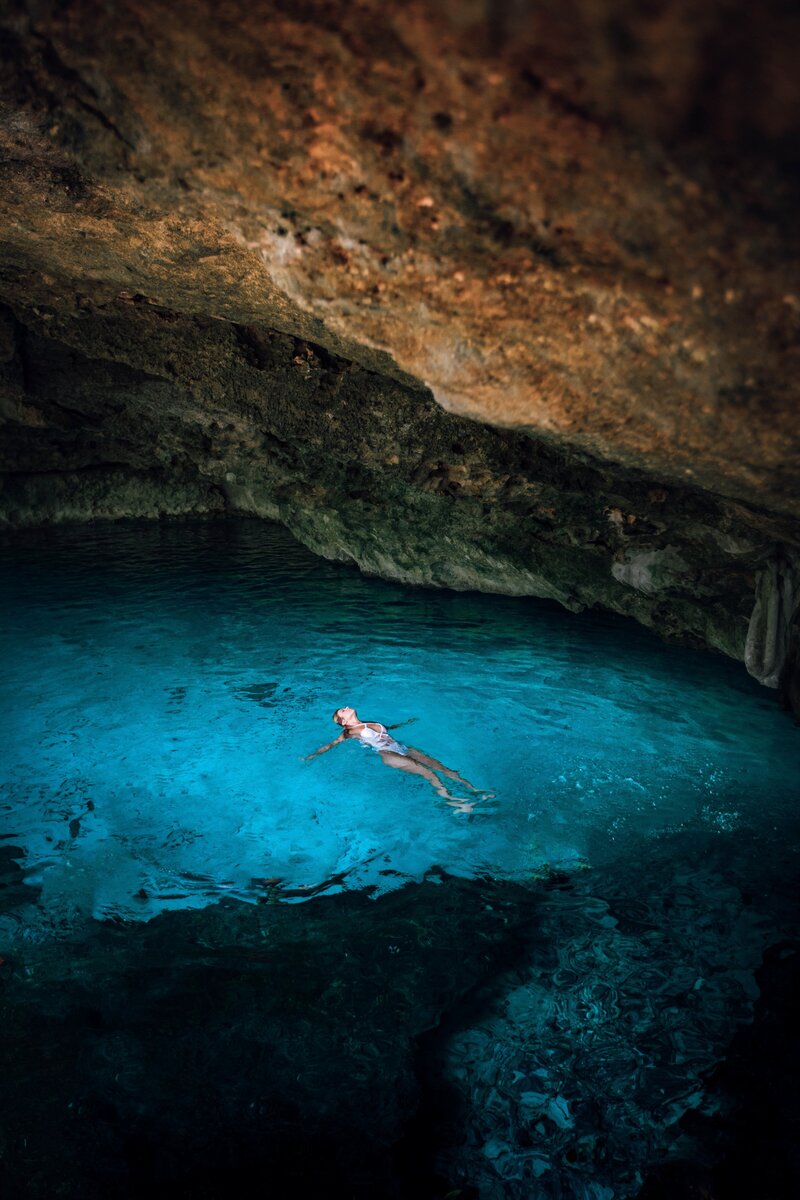 swimming in a cenote on the best yoga retreat in mexico