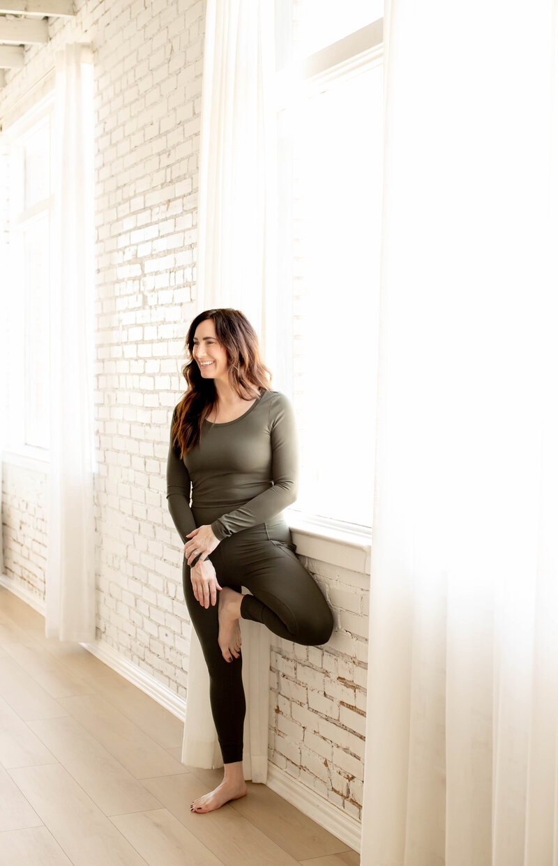 Woman next to window happily chatting