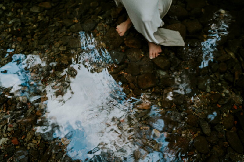 feet in a still greek with a rocky bottom