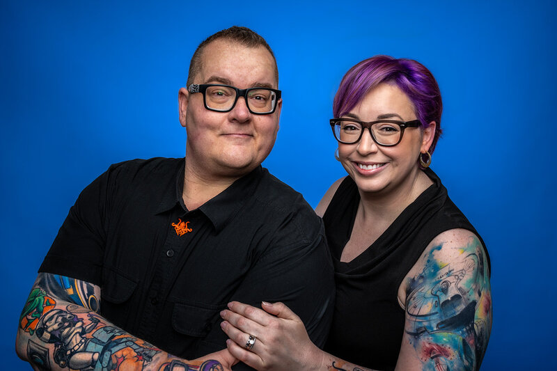 portrait of garrette and amber baird on a blue bakcround