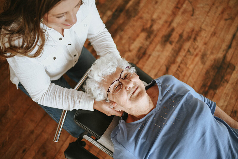 Chiropractor adjusting an elderly woman