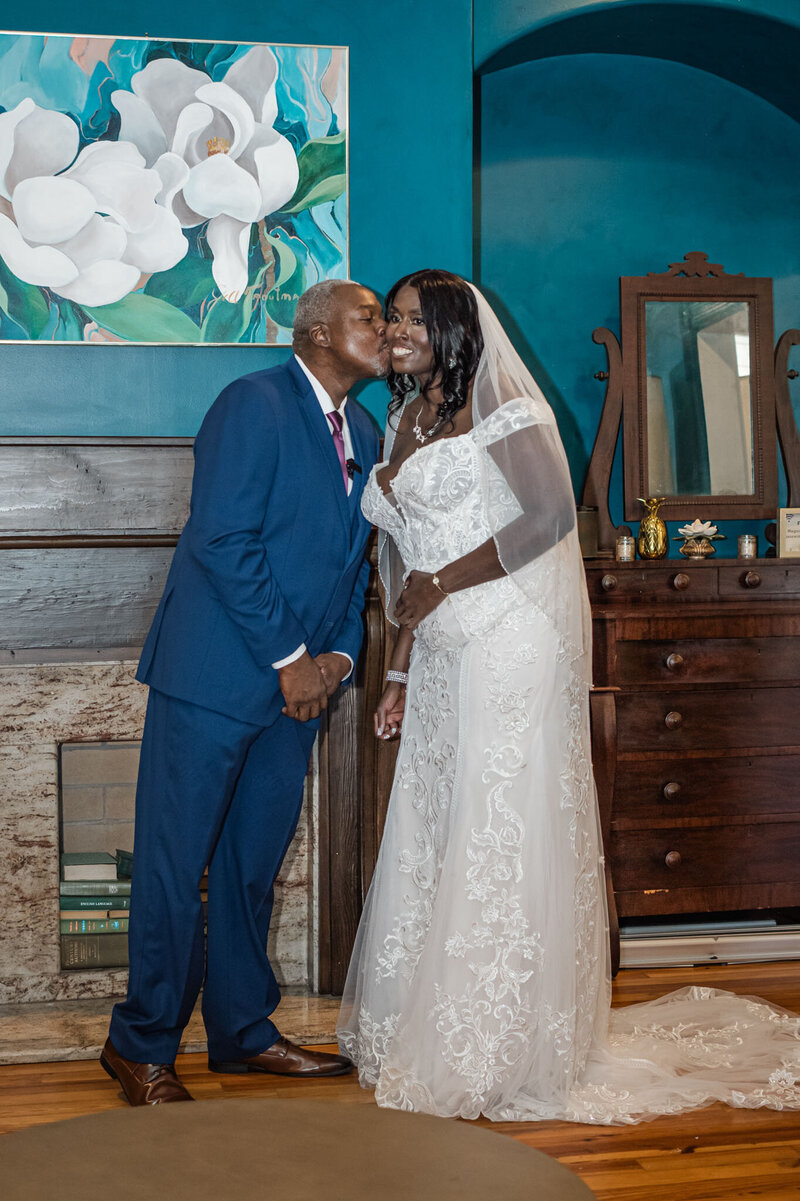 Groom kissing brides cheek