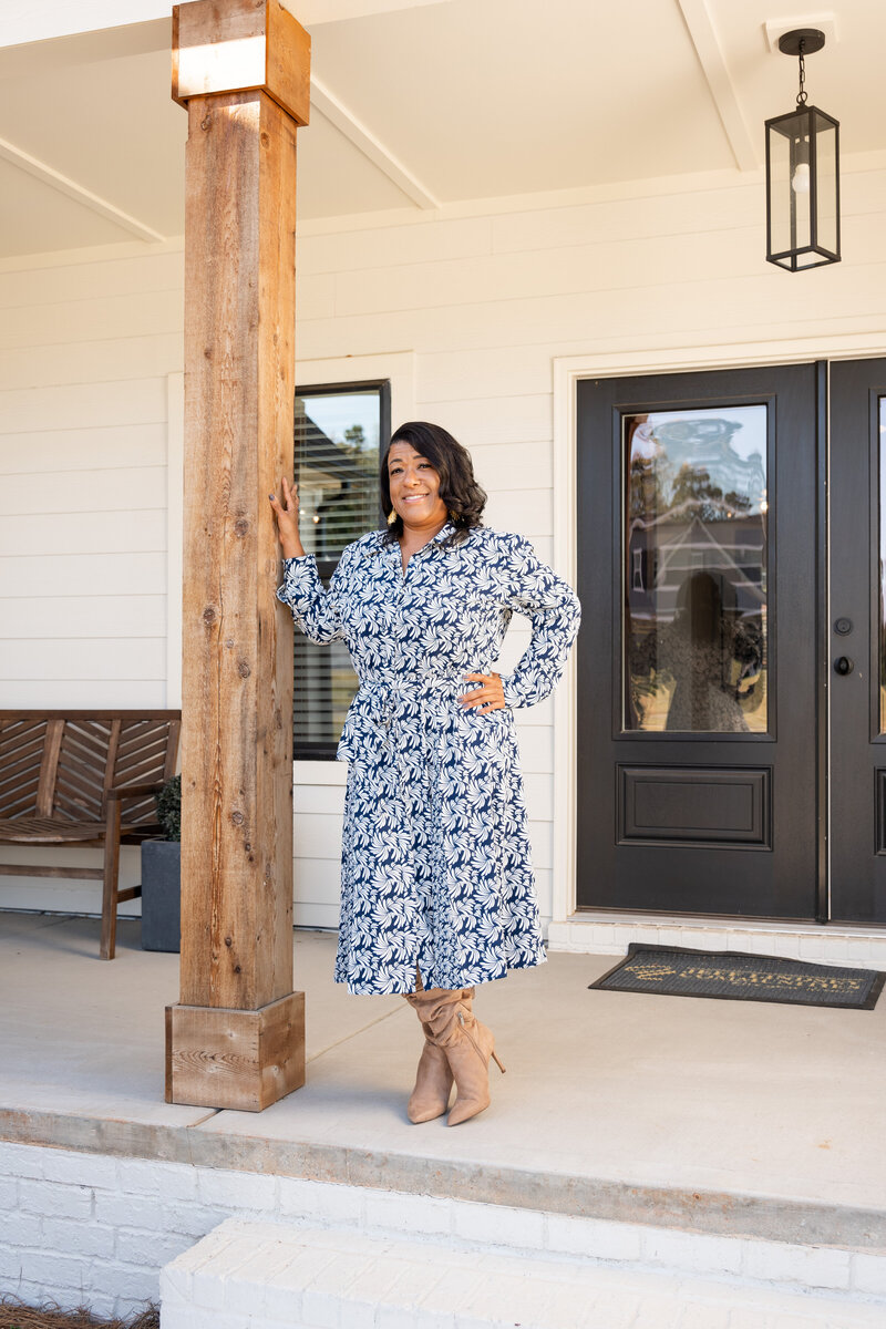 Realtor standing in front of a home for branding photos