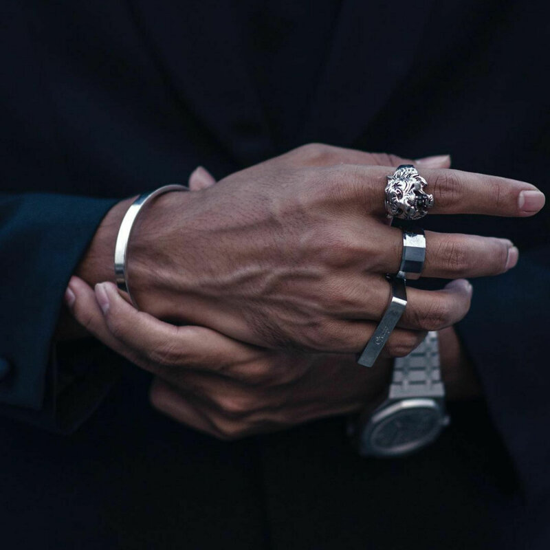 closeup-businessman-s-hands-with-ornate-silver-tiger-ring-other-accessories