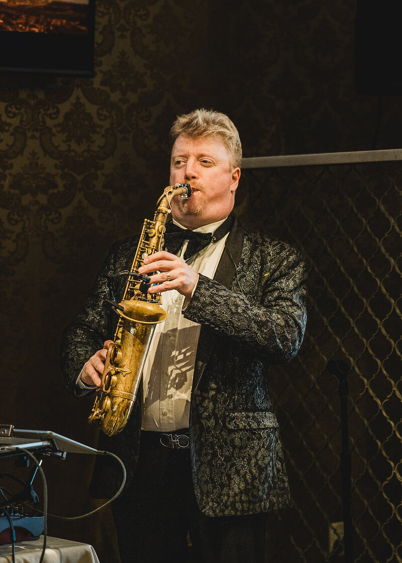 Candid photo of musician at a birthday gala.
