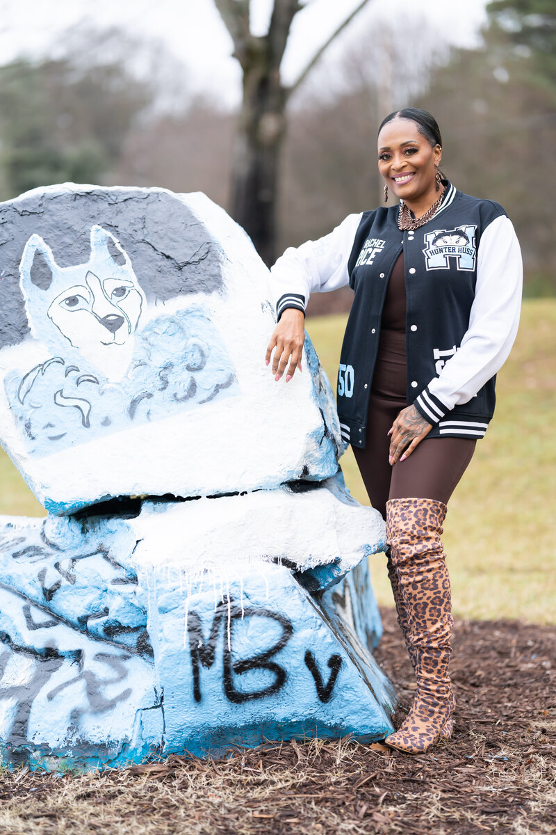 50th milestone birthday photoshoot woman wearing letterman jacket