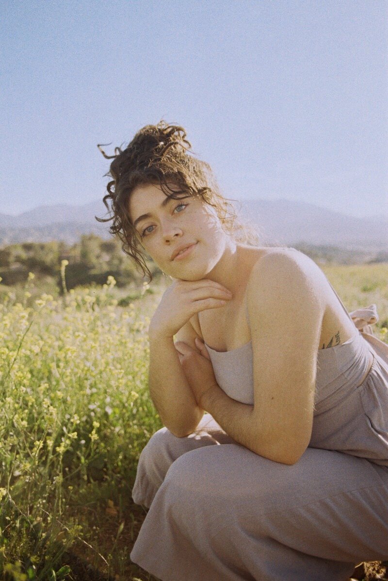 Warm, outdoor brand portrait taken by photographer Puerto Rico in a wildflower meadow

