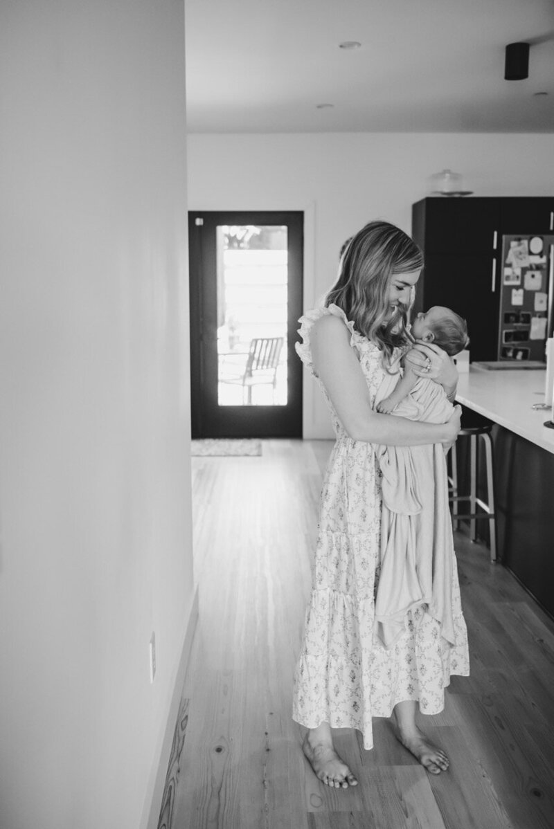 A natural light, in-home lifestyle newborn photography session of a sleeping newborn, photo taken by Kristin Wieskamp