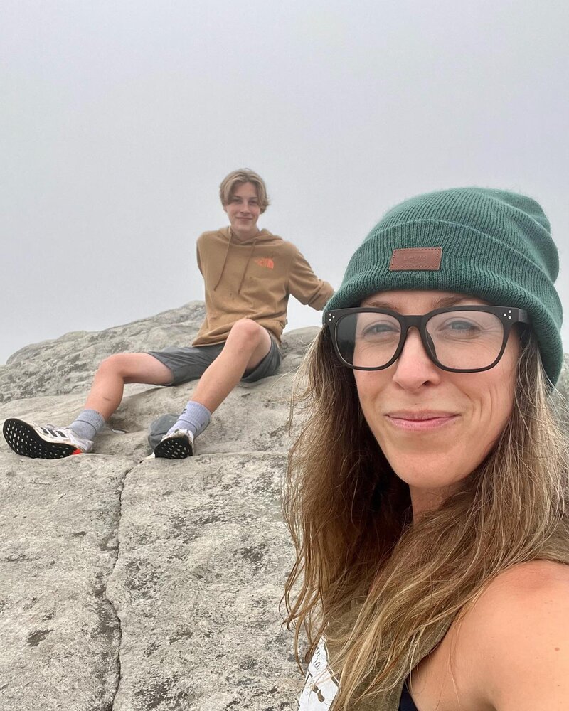 mother and son sit on North Carolina mountain top