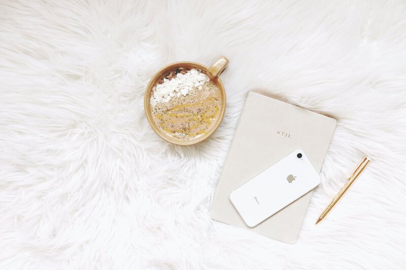 coffee, notebook, phone and pen on rug