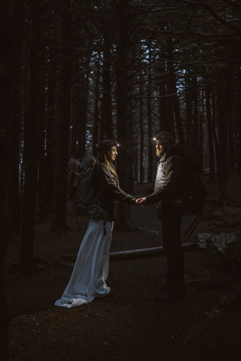 Couple holding hands and smiling on their elopement day after their ceremony