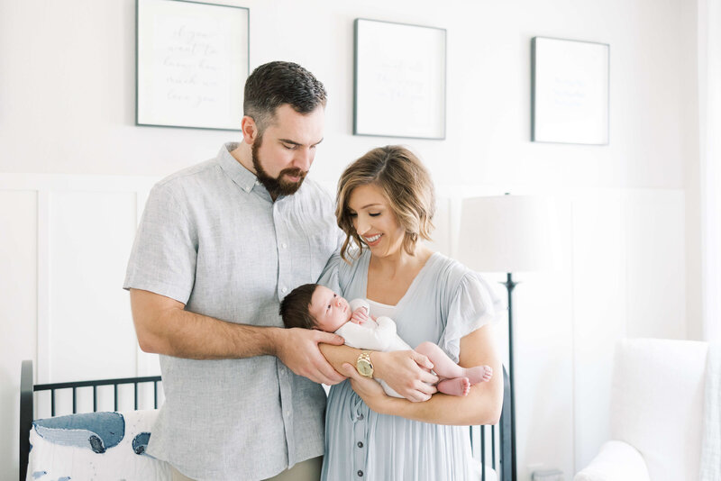 parents holding their newborn in the nursery