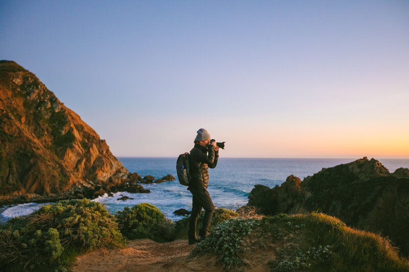 woman photographs landscape in California Bay area