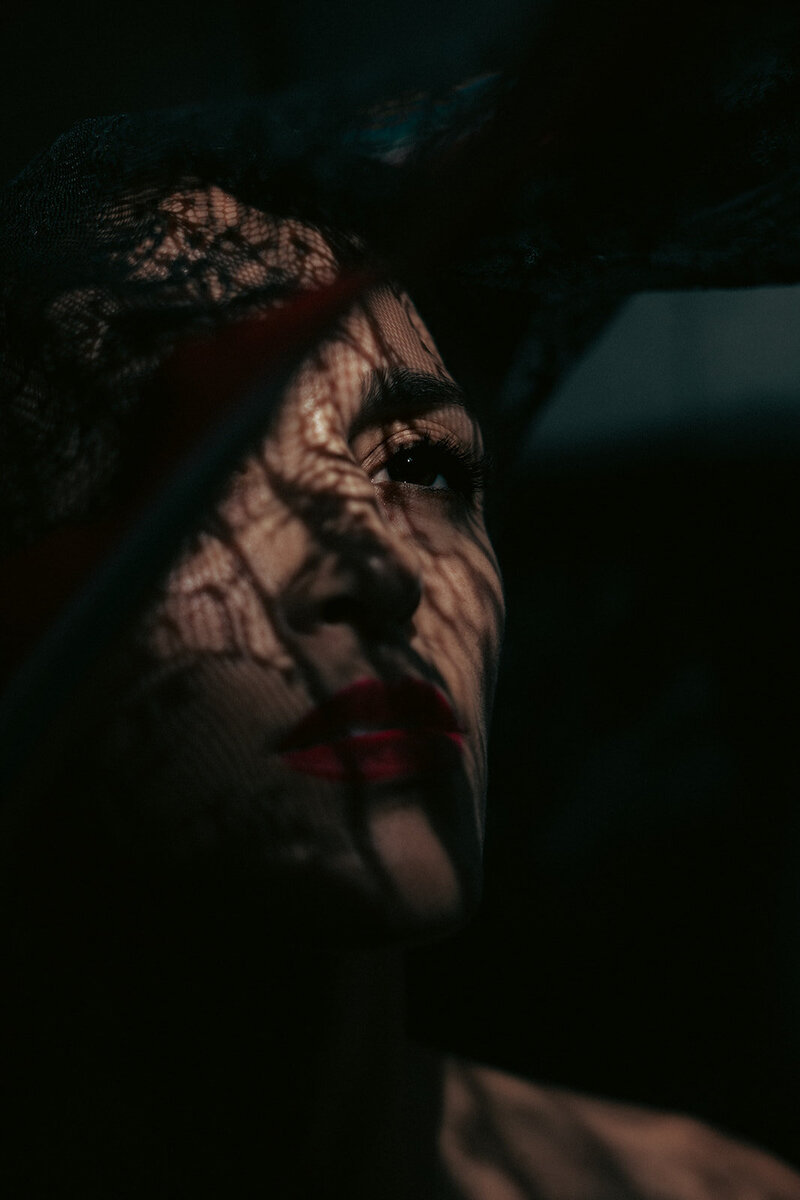woman close up portrait under lace shadow