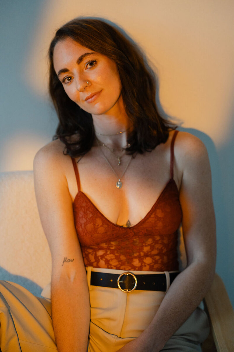 female smiling sitting on comfy white chair