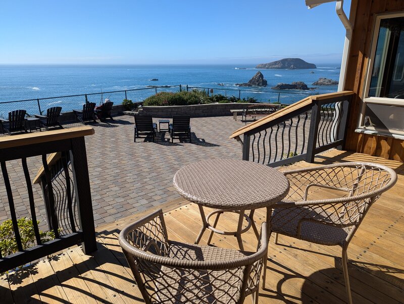 Deck with table and chairs and an ocean view