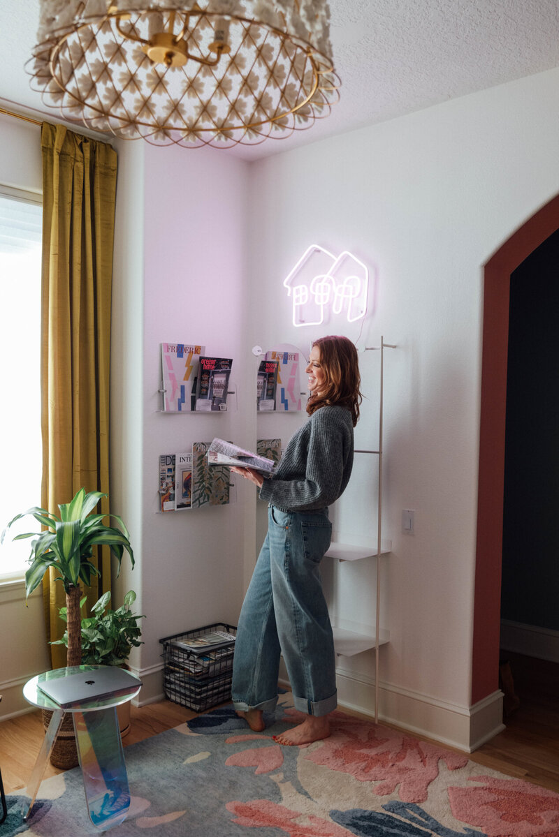 Interior Designer Erin Lima in her home office featuring colorful and eclectic home decor. 