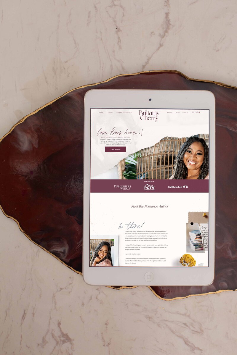 showit website being displayed on a while ipad placed on a purple stone background