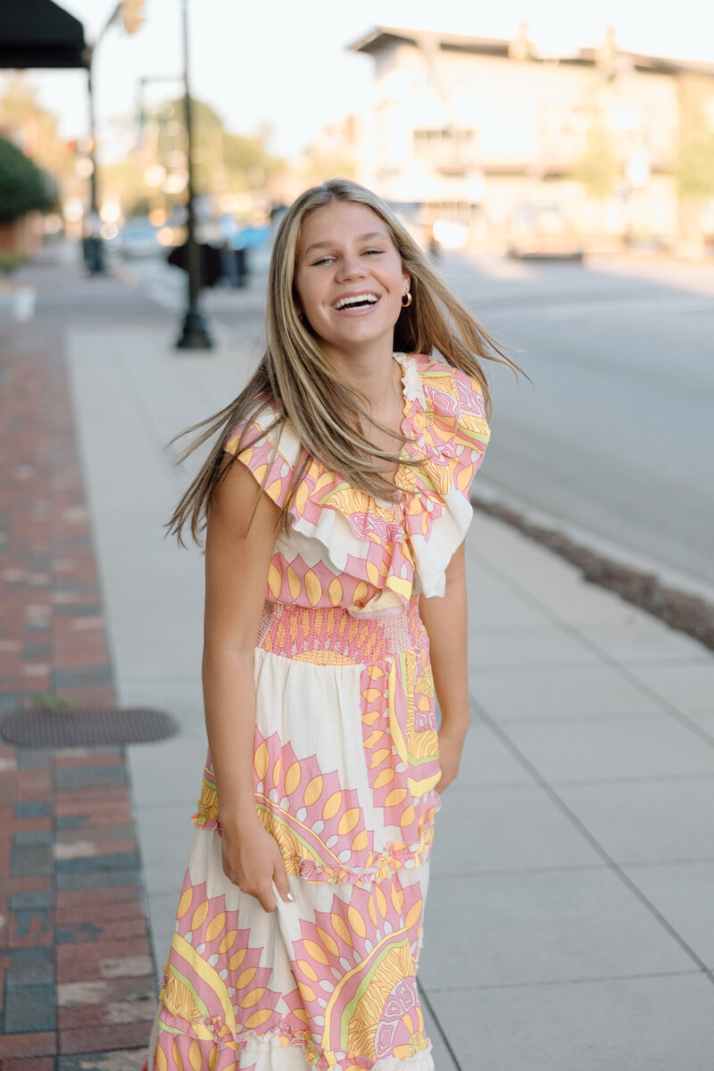 Senior twirls around and smiles