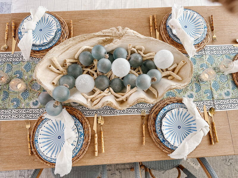 a large seashell filled with ocean rocks and driftwood