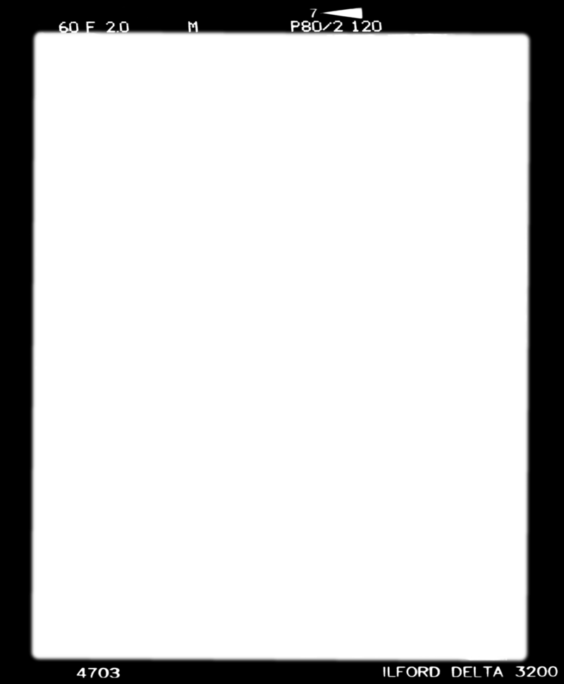a digital scan of a film frame negative. It shows that the image was taken at 1/60th of a second at f2.0. Ilford Delta 3200 is the film stock, and 4703 is the number. M for shot in manual on 120 film