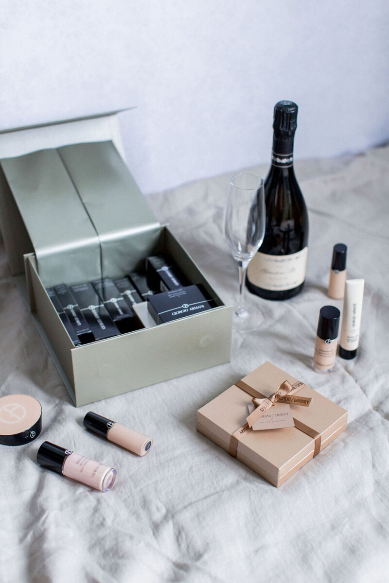 Armani Beauty press mailer with bespoke box of chocolates, Armani foundation and concealer samples and a bottle of champagne