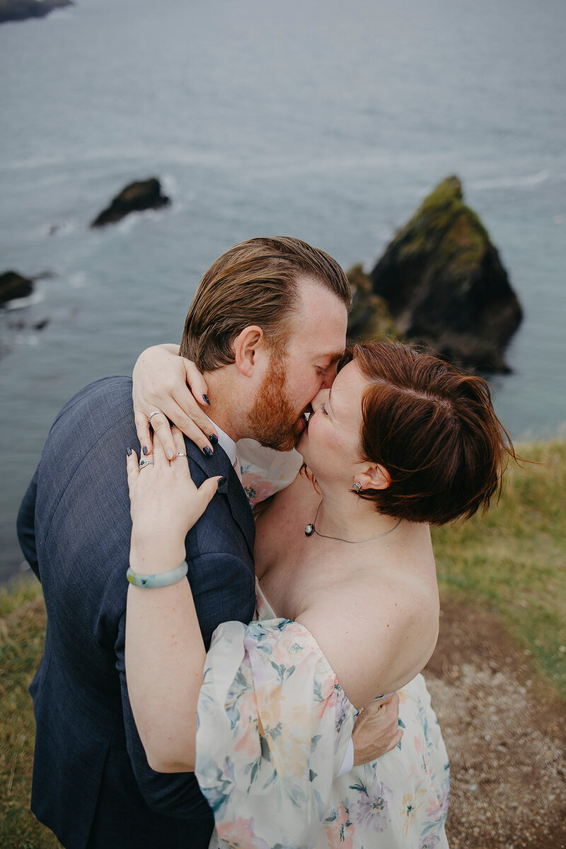 Romantic vow renewal at Dingle Cliffs, with the couple surrounded by the cliffs of Dingle, overlooking the wild Atlantic."