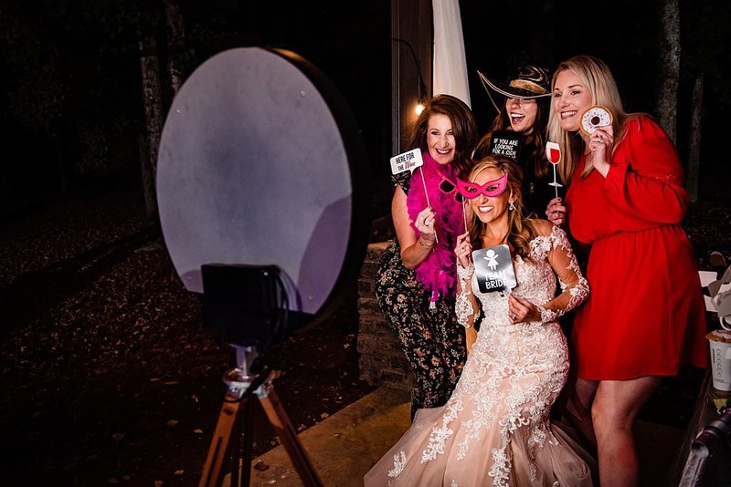 Bride and her girlfriends using props in Social Photobooth