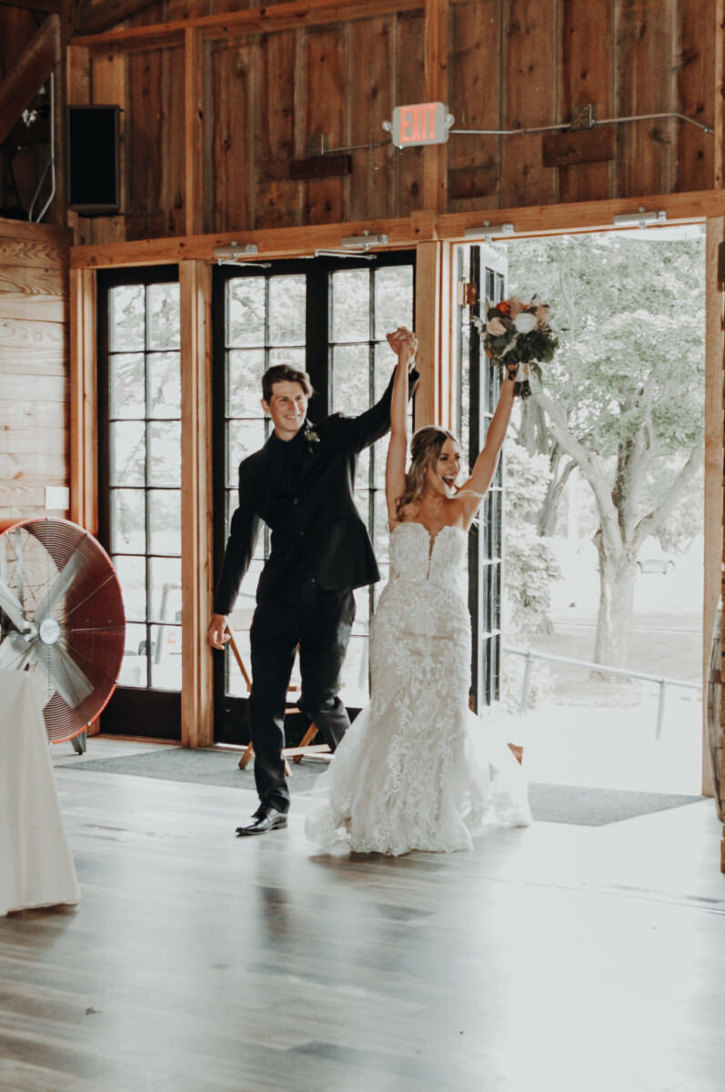 Bride and groom enter their wedding reception