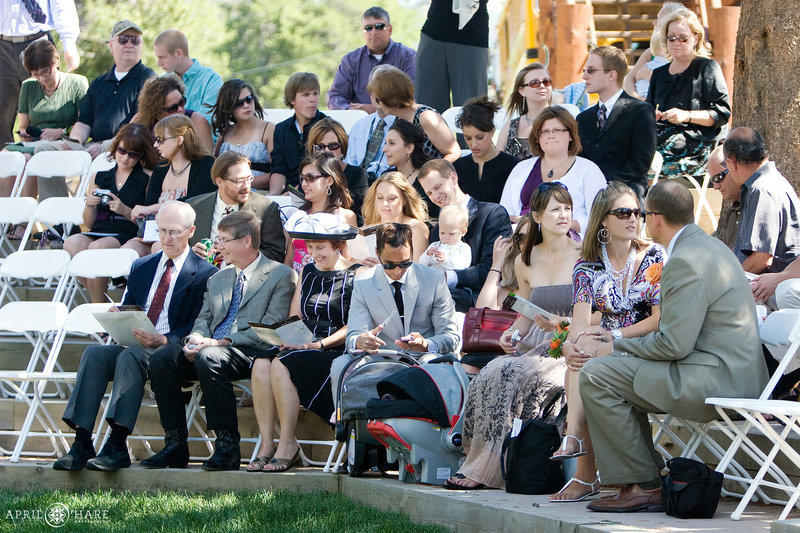 Wedding guests sit on risers outside at Agape Outpost Chapel in Breckenridge
