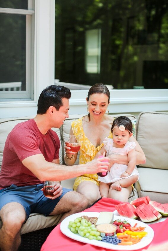 Vanessa Flores enjoying a family moment outdoors with fruit and drinks — balancing midlife, motherhood, and wellness