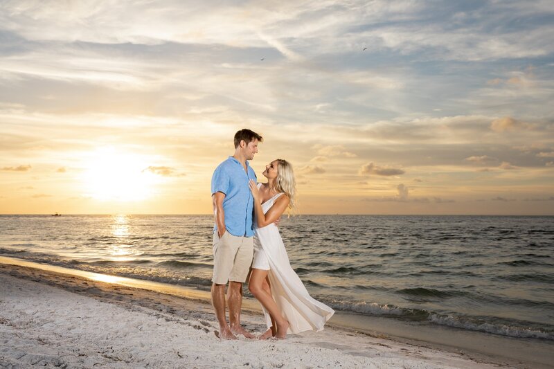 Sarasota-Bradenton Engagement Photography of couple holding hands walking on the beach at sunset