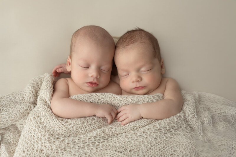 Timeless portrait of twin newborn boys wrapped in a cozy cream blanket – photographed in Paris, Ontario.