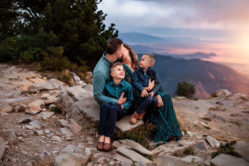 family on mountain top at sunset photo