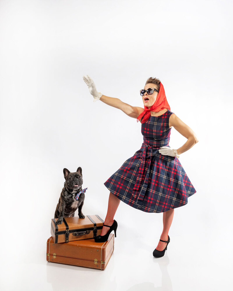 Pinup model with dog on suitcase