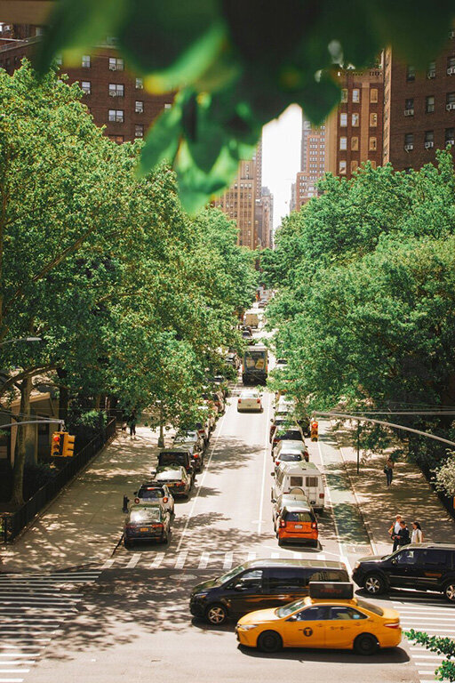 Busy NYC street filled with cars and yellow cabs, showcasing the vibrant city life.
