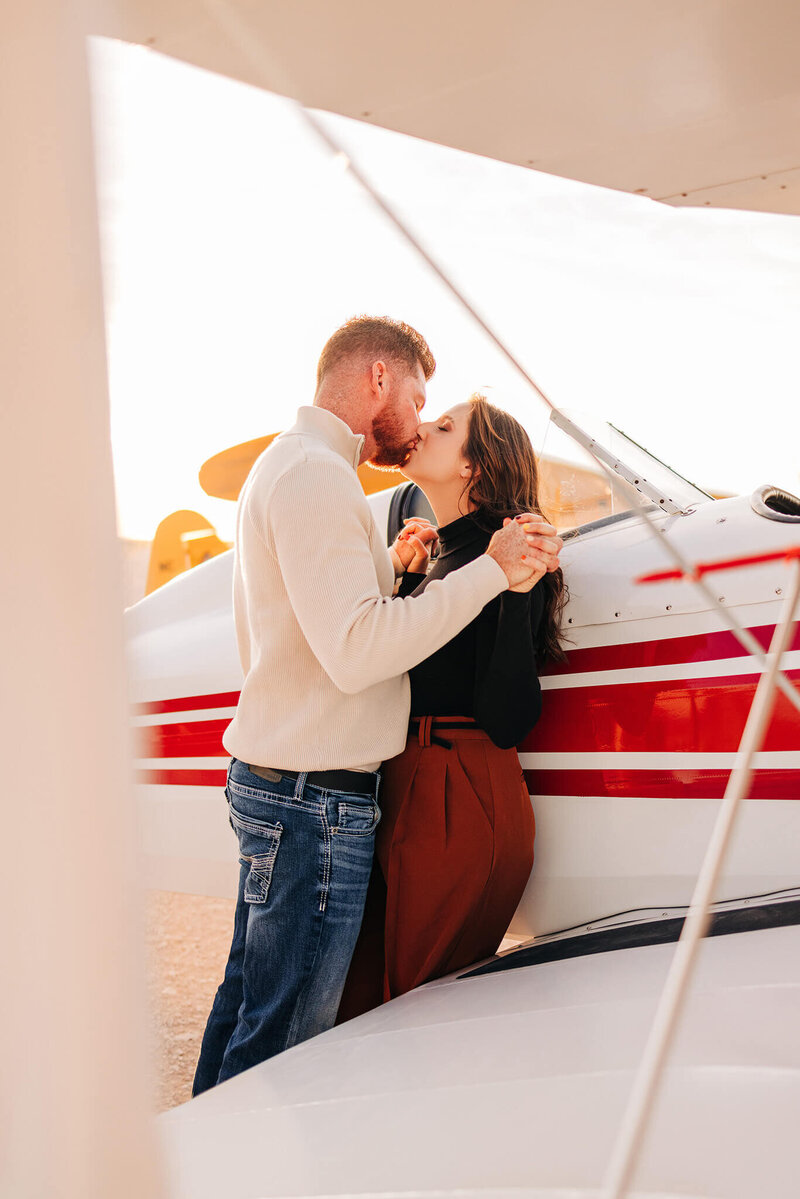 intimate moment of a couple with airplanes