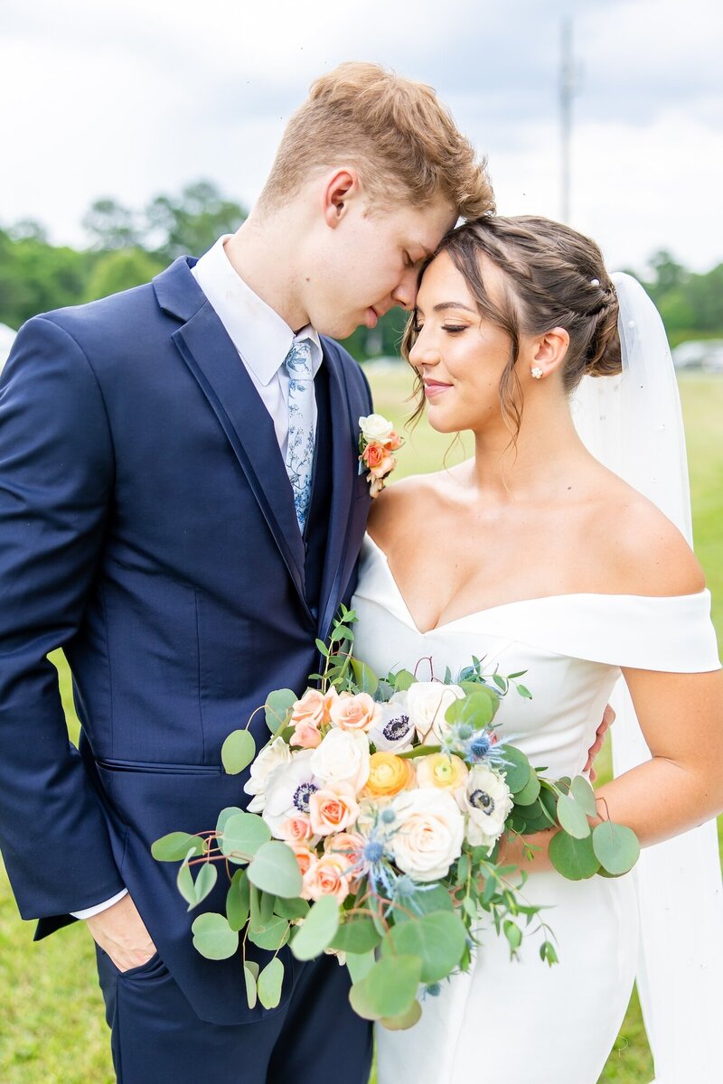 Groom gently resting his forehead on his bride
