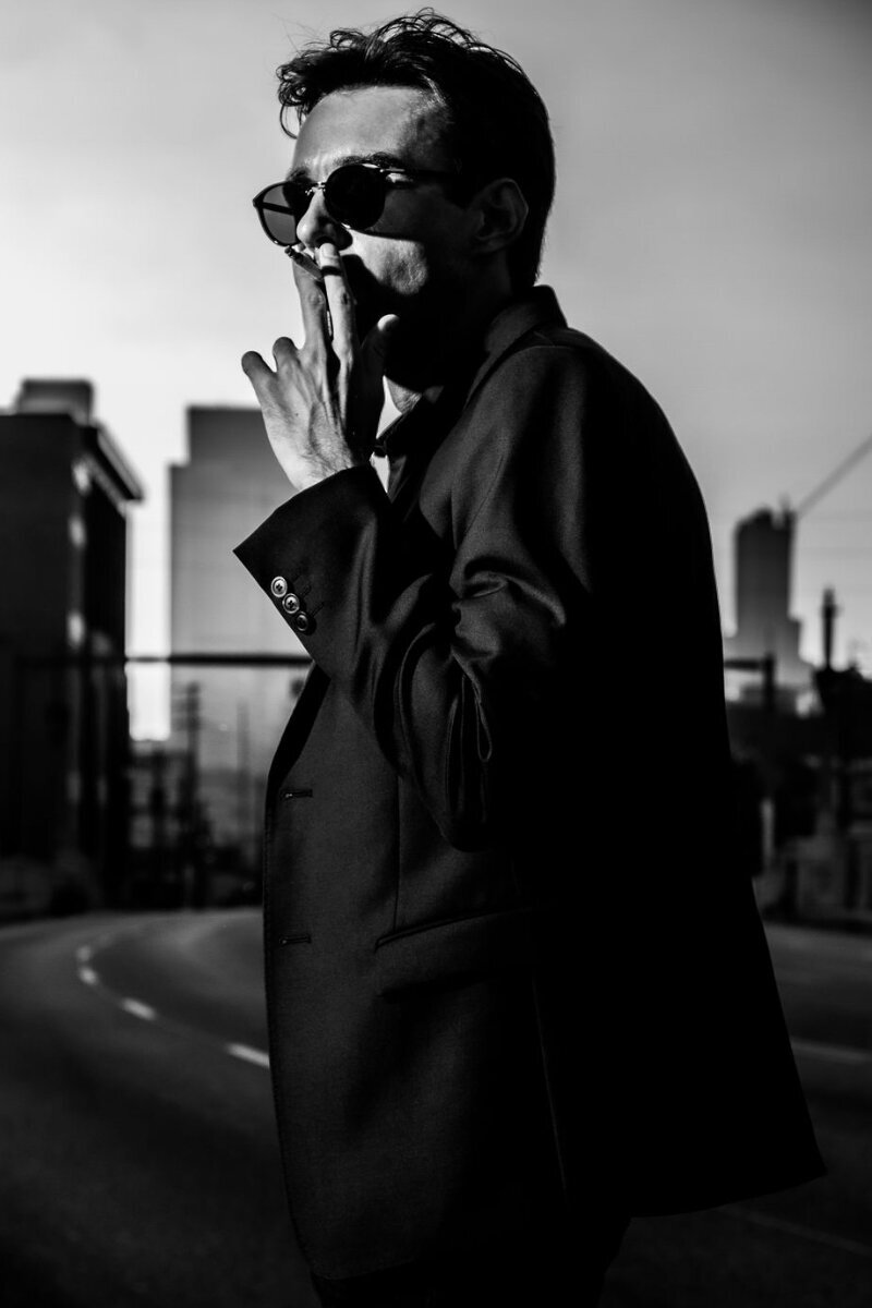 Chandler Morrison Professional Branding Image black and white  walking down street while smoking cigarette wearing sunglasses