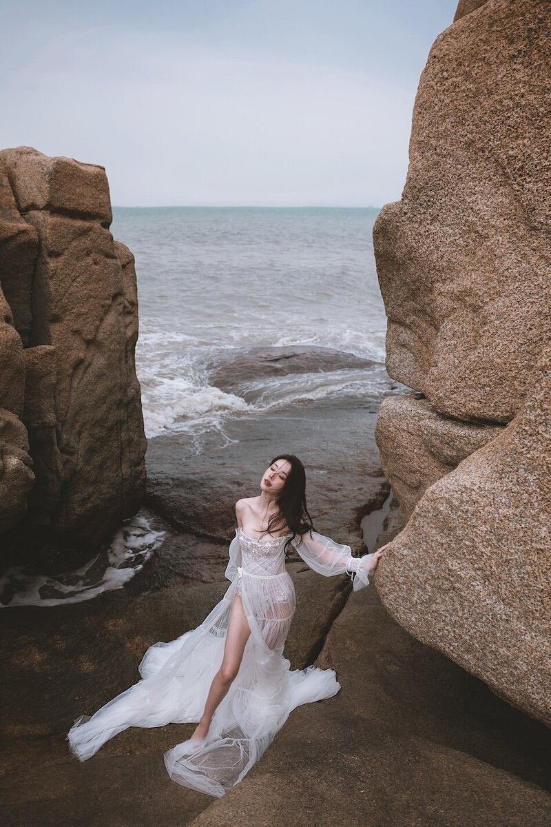 A beautiful windswept beach couture shoot amongst coastal rocks.