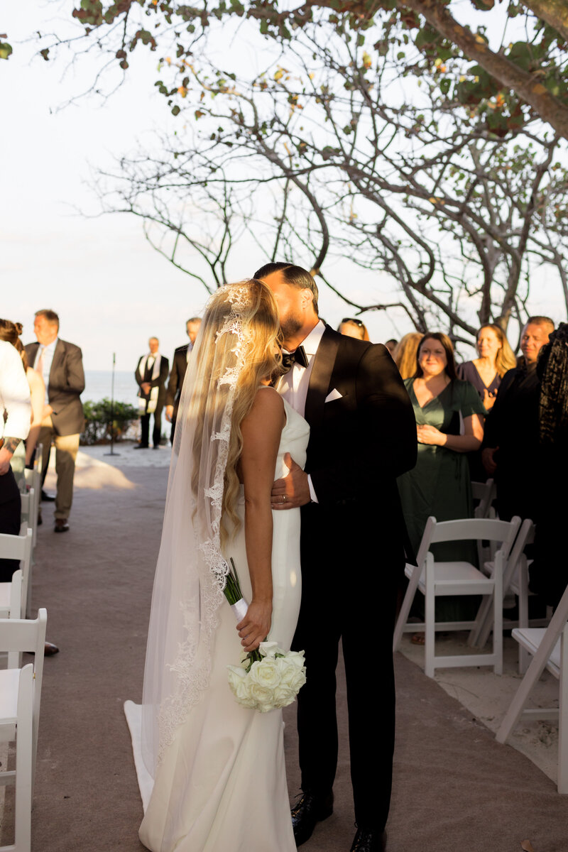 Bride and groom walk towards building