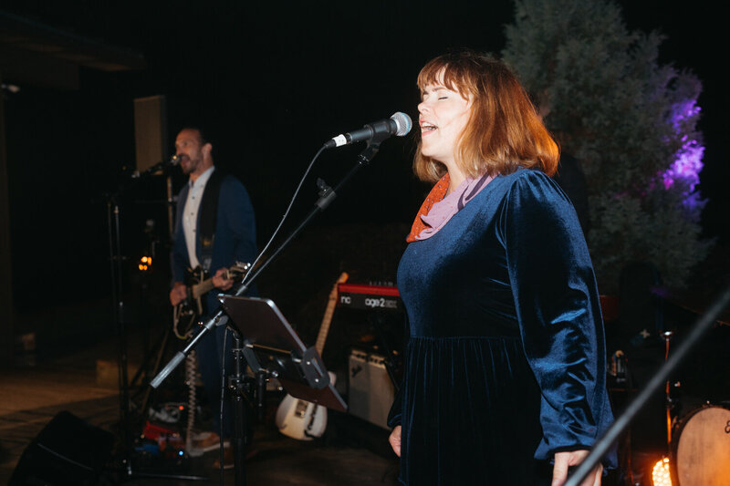 Elopement Reception Ideas | The singer of a live band sings into a microphone for a unique Elopement Reception Idea