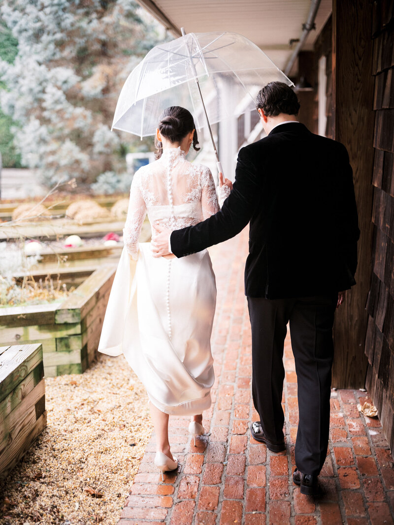 Bride and groom walk away from camera